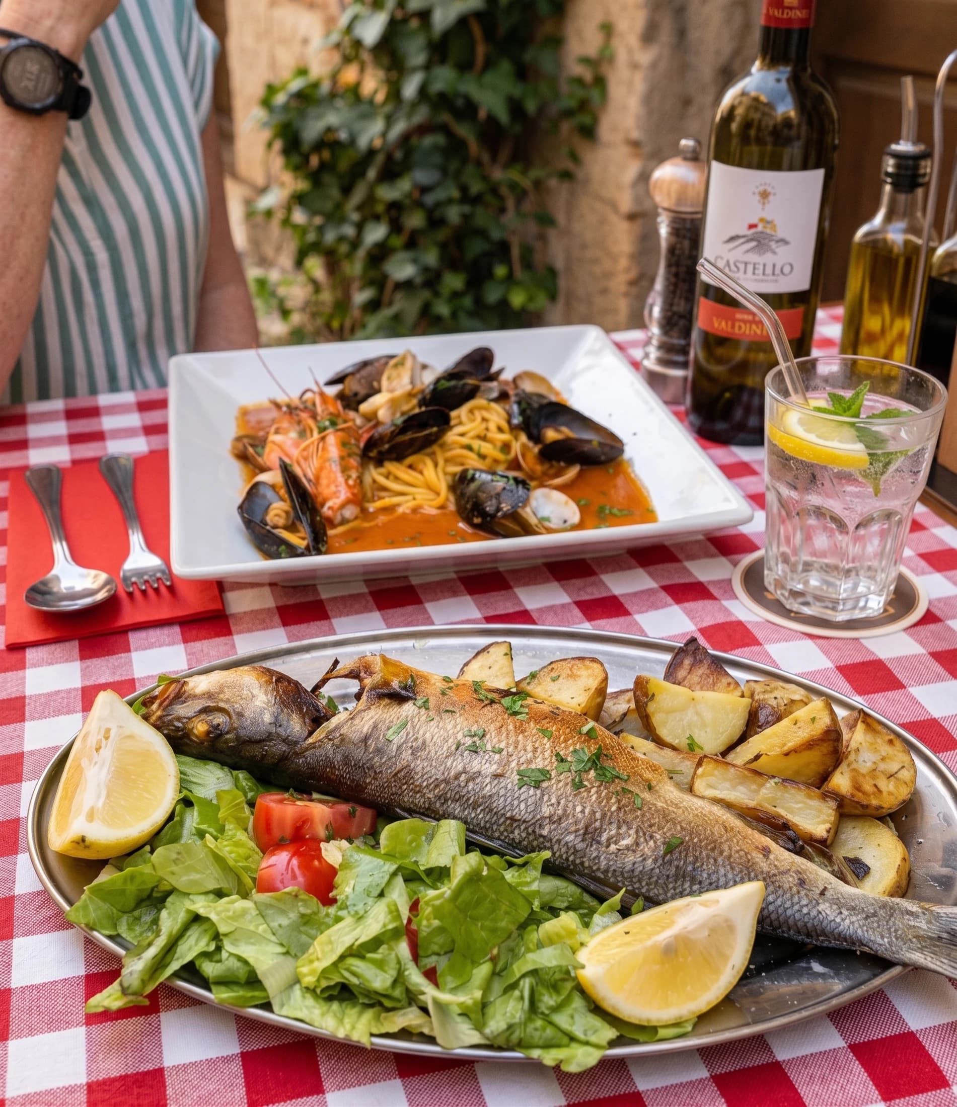 A seafood platter with grilled fish and salad