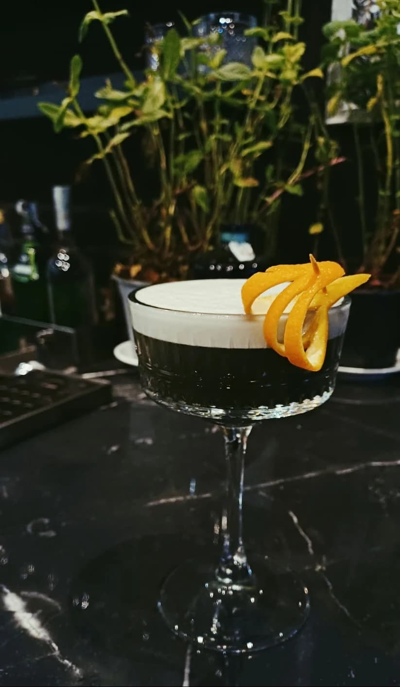 A coffee-dusted cocktail with an orange twist