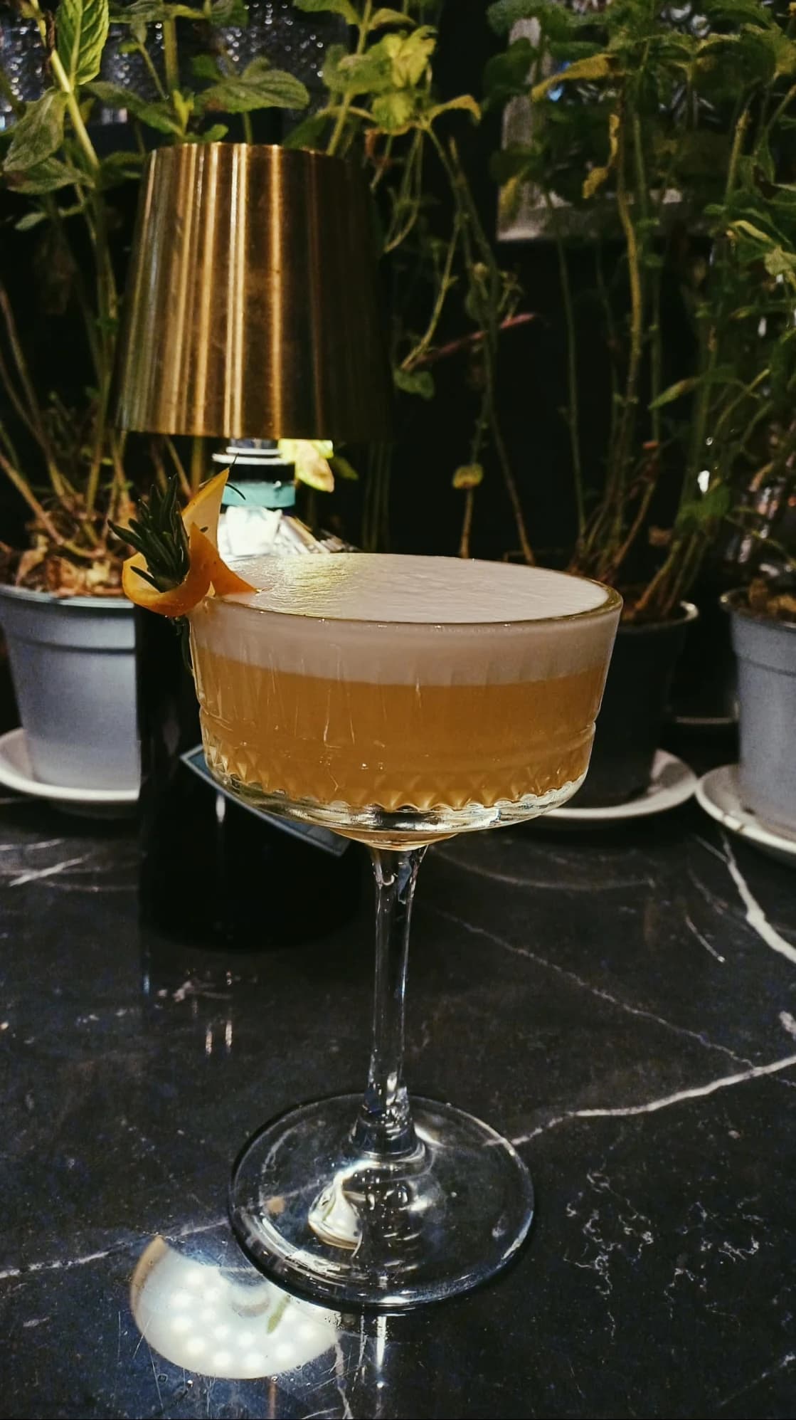 An amber cocktail with a citrus twist