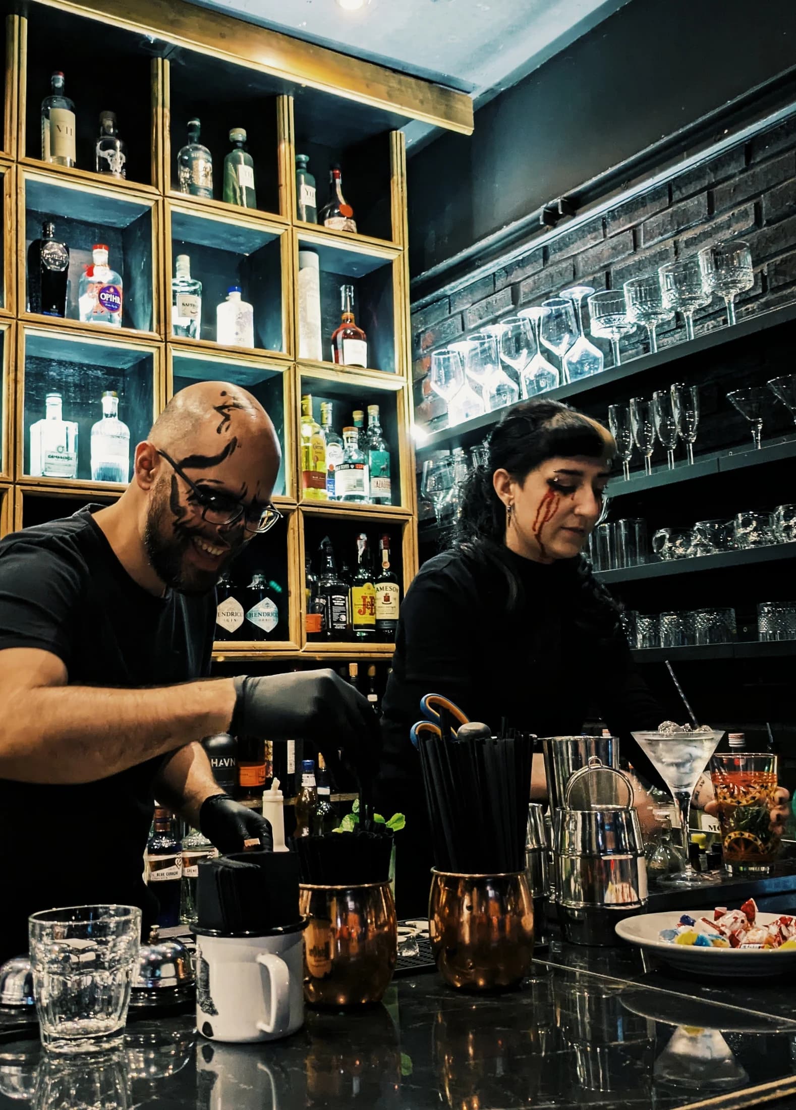 Two bartenders working together behind the bar